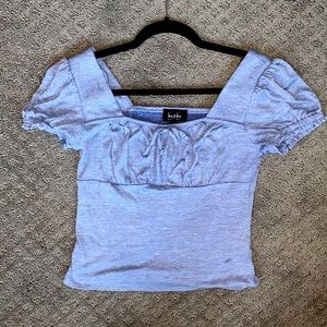 Baby blue peasant blouse with a square neck.